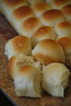 bread rolls cut in half on a cutting board