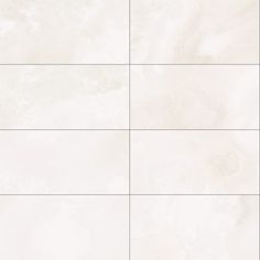 a white tile wall with four different tiles on it's sides and one is empty