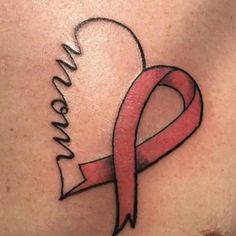 a woman's breast with a pink ribbon and name tattoo on the side of her chest