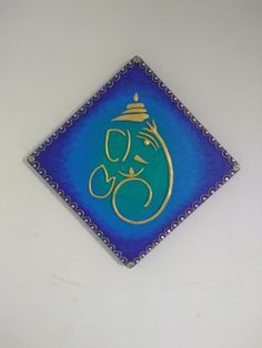 a blue and gold tile with an elephant on it