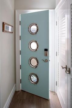 a blue door with three portholes on it