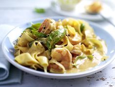 a white plate topped with pasta covered in sauce