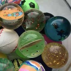 a bowl filled with lots of different colored balls