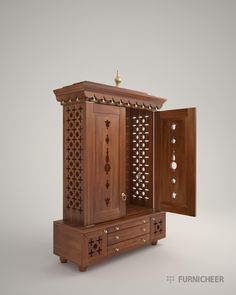 an open wooden cabinet with intricate carvings on the doors and drawers, in front of a gray background