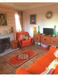 a living room with orange couches and a fire place in the middle of it