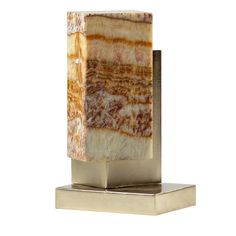 a marble block on a metal stand with a white background and gold trimmings