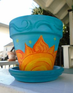 a blue flower pot sitting on top of a white table