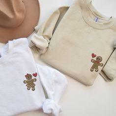 🎄🍪 Step into the holiday spirit with our delightfully sweet Embroidered Matching Couples Christmas Sweatshirt featuring charming Gingerbread people! This season, stand out in the holiday crowd with a uniquely crafted Christmas Sweatshirt, perfect for couples eager to showcase their unity and festive cheer. Choose between a delightful Gingerbread man or Gingerbread woman, or mix and match for the perfect His and Her pairing. Be the envy of every Christmas gathering as a Christmas couple, exuding warmth, style, and holiday affection in your custom-tailored Xmas Couple Sweater. Our Embroidered Sweatshirt is a masterpiece of Custom Embroidery, ensuring every Gingerbread detail is stitched to perfection, bringing the holiday characters to life. The Embroidered Crewneck is designed for comfort Ugly Sweater Couple Ideas, Matching Sweaters For Couples, Couple Christmas Sweaters, Gingerbread Woman, Couples Christmas Sweaters, Matching Ideas, Matching Christmas Sweaters, Holiday Characters, Xmas Couple