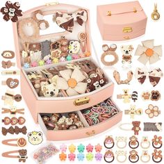 a pink suitcase filled with lots of assorted jewelry and earring pieces on top of each other