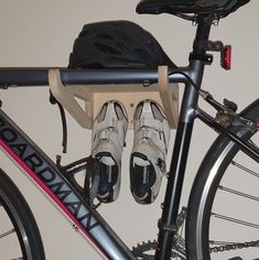 there is a pair of shoes that are on the rack next to a bicycle and helmet