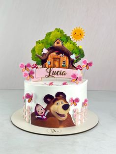 a birthday cake with masha and the bear on it's top is shown