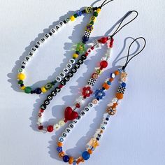 three bracelets with different designs and colors on them, one is made out of glass beads