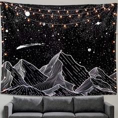 a black and white wall hanging over a couch