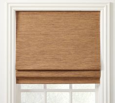 a brown roman blind in front of a window