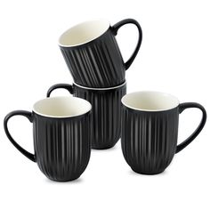 four black and white coffee mugs stacked on top of each other