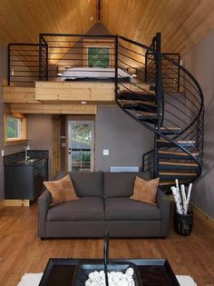 a living room filled with furniture and a spiral staircase