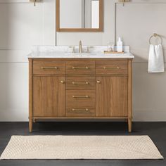 Embrace contemporary style for your bathroom renovation with the Rian vanity by allen + roth. With a warm walnut finish, smooth white countertop and gold hardware accents, it's the perfect mix of trendy and timeless. It offers plenty of storage for tucking away all your grooming essentials thanks to 2 tilt-down drawers, 2 cabinets, 2 adjustable inner shelves, 1 u-shaped drawer and 1 double-deep drawer. In just one look, you'll see why it's the ideal piece for any small bathroom or guest ensuite. Bathroom Vanities Single Sink 48 Inches, 48" Bathroom Vanity Ideas, Inset Bathroom Vanity, 42” Bathroom Vanity, Bathroom Single Vanity Ideas, 48 Inch Bathroom Vanity Single Sink, Walnut Vanity Bathroom, Single Sink Bathroom Vanity Ideas, Oak Vanity Bathroom