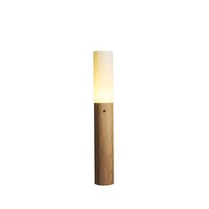 a light that is sitting on top of a wooden pole in the middle of a room