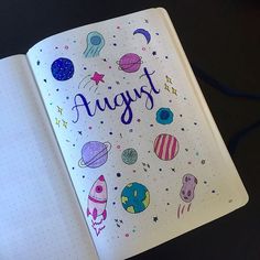 an open notebook with the words august written on it and space themed stickers around the pages