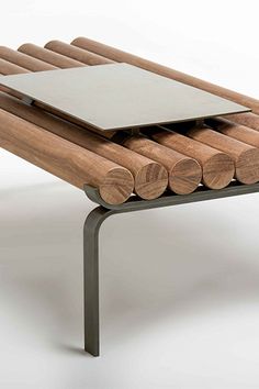 a wooden bench with metal legs and a tablet on top