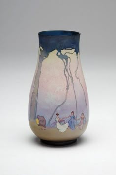 a small vase with people walking on the ground in front of trees and sky behind it