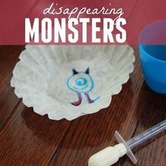 a disposaring monster paper plate next to a blue cup and syosher