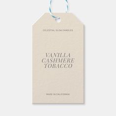 vanilla cashmere tobaco label with blue string on white paper tag that reads, celestial glow candles vanilla cashmere tobaco made in california