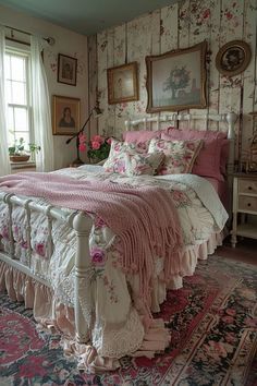 a large bed sitting in a bedroom next to a window covered in pink blankets and pillows