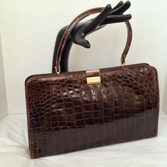 Vintage Handbag "Made In France For Saks Fifth Avenue." Of Genuine Chestnut-Brown Crocodile Skin. Rectangular And Large, The Frame Covered With Crocodile Skin, It Has A Center Snap Closure And Two Additional, Crowned With A Crocodile Handle. The Interior Is Lined In Dark Brown Leather, Several Pockets. Minor Flaws Please Review All Pics. Questions? Leave A Comment Below! Elegant Brown Bag With Crocodile Pattern, Elegant Brown Crocodile Pattern Shoulder Bag, Elegant Brown Crocodile Pattern Bag, Evening Brown Bag With Crocodile Pattern, Brown Crocodile Pattern Evening Bag, Alligator Purse, Alligator Handbags, France Colors, Vintage Handbag