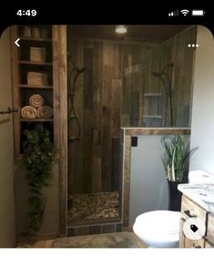 a bathroom with a sink, toilet and shower stall in the middle of it's room