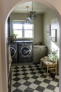 a washer and dryer in a small room with checkered flooring on the floor