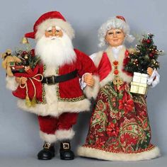 two christmas figurines standing next to each other