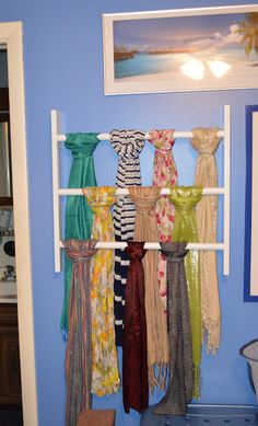 there are many dresses hanging on the rack in this room with blue walls and white trim