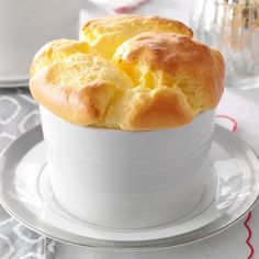 a white bowl filled with bread on top of a table