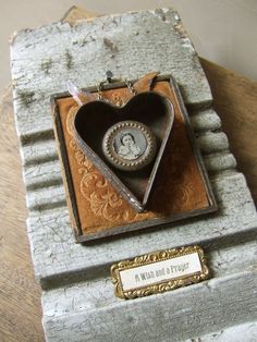 a heart shaped box sitting on top of a wooden table