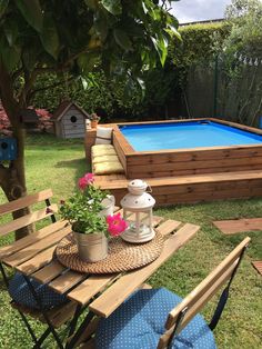 a backyard with a pool and deck furniture