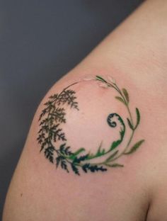 a close up of a person's arm with a tattoo design on the shoulder