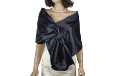 a mannequin wearing a black and white dress with a large bow on it