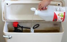 a person is pouring water into a cooler