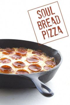 a skillet filled with pepperoni pizza on top of a white counter next to a sign that says soul bread pizza