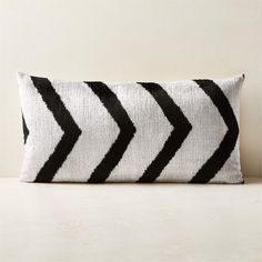 a black and white striped pillow sitting on top of a table