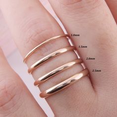 three different sizes of rings are shown on someone's hand, with measurements for each ring