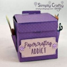 a close up of a purple box with writing on it and some pencils in it