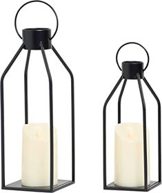 two black metal lanterns with white candles in them, one is open and the other has a candle inside