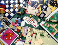 a table topped with lots of different types of board games