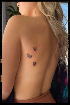 a woman with three butterflies on her back