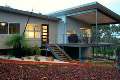 a house with a deck and stairs leading up to it