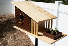 a wooden bird house with plants in it