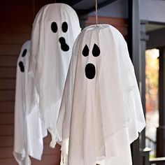 two ghost decorations hanging from the side of a house with text that reads, halloween door decorations great wreaths and entry accents