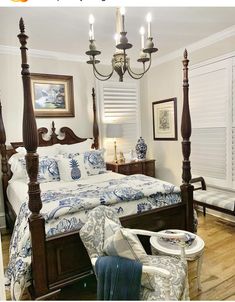 a bedroom with a four post bed, blue and white comforter, two nightstands on either side of the bed